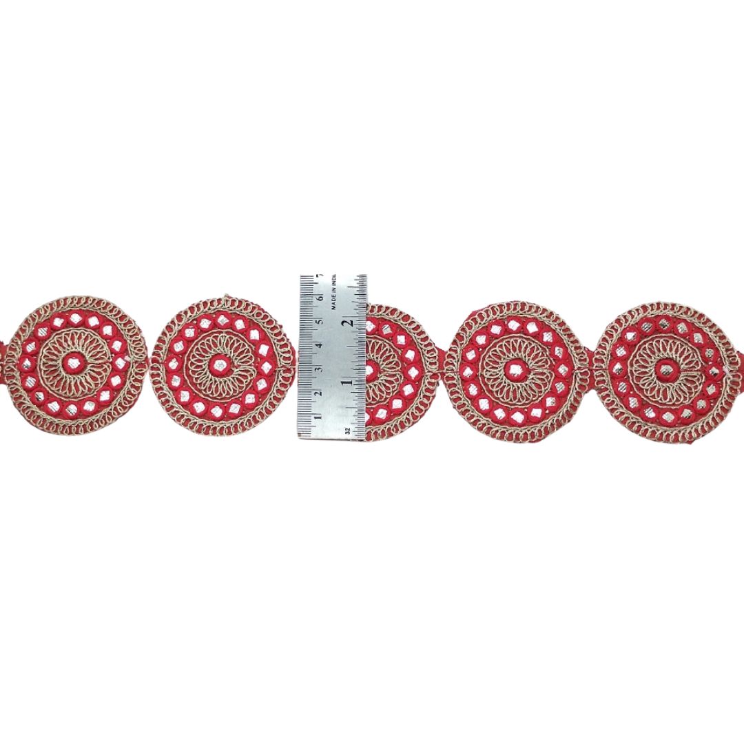 Decorative red and gold trim with a ruler for scale on a white background